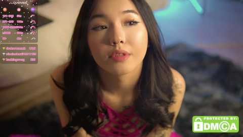 Media: Video of an Asian woman with long black hair, wearing a pink lace top, making a kissy face, with a live stream watermark.