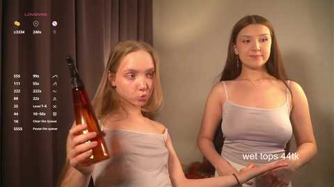 Media: Video of a young, fair-skinned girl with straight brown hair in a white tank top, holding a brown bottle, with a blurred background and a \"weft tops 4k\" watermark.