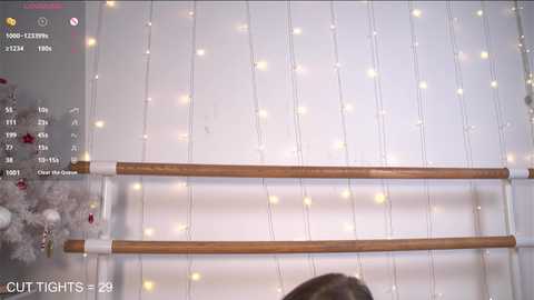 Media: A video shows a festive room with white string lights, a wooden railing, and a snowflake garland. A video game interface with \"Cut Tights\" overlay is visible in the top left corner.