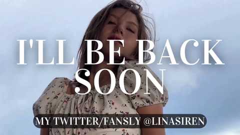 Media: Video of a young girl with messy hair, wearing a floral dress, standing against a cloudy sky. Text overlay reads: \"I'LL BE BACK SOON,\" with a Twitter/Fansly/Linasiren handle at the bottom.