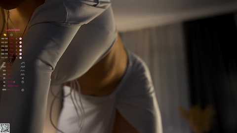 A CGI-rendered image depicts a close-up of a person wearing tight, white leggings, highlighting their muscular legs and toned physique. The background is dimly lit with blurred elements, suggesting an indoor setting.