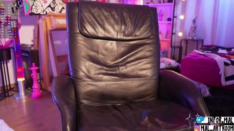 A video of a dark brown leather recliner chair in a brightly lit, eclectic bedroom with purple and pink accents, featuring a bed, shelves, and colorful decor.