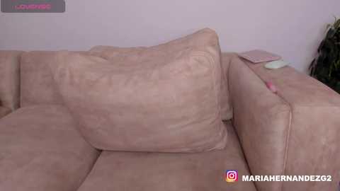 Video of a plush, beige couch with a large, wrinkled cushion, featuring a watermark \"MARIAHERNANDEZ92\" in the bottom right corner.