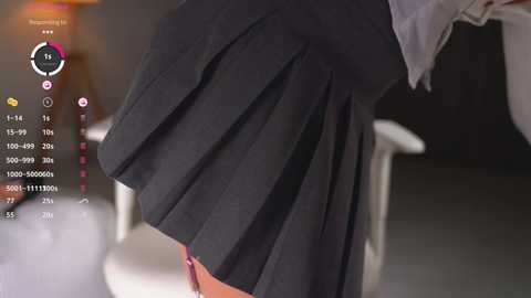 Media: Video of a person wearing a black pleated skirt, blurred background. UI elements on the left include a timer, battery, and camera settings.