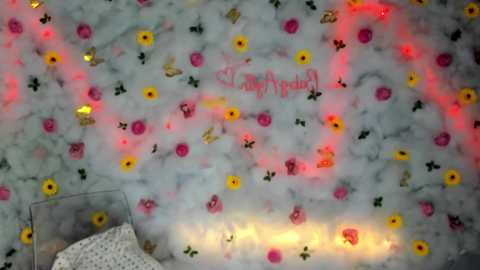 Media: Video of a festive, colorful marble-topped table with a white tablecloth featuring a pink, yellow, and green floral design. A message reads \"Happy Birthday\" in pink cursive.