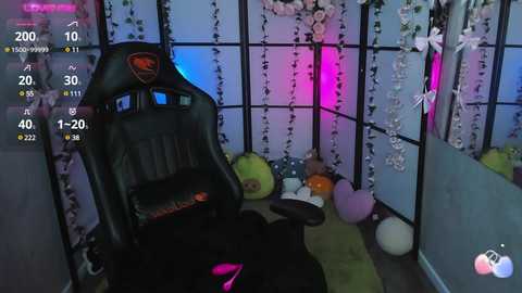 Media: Video of a cozy, dimly lit room with a black gaming chair, colorful decor, and soft furnishings.