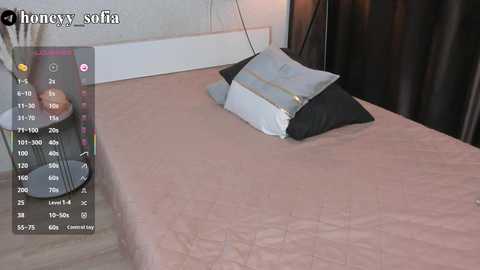 Media: Video of a modern bedroom with a beige bedspread and black pillow, featuring a smartphone display overlay with temperature and humidity readings.