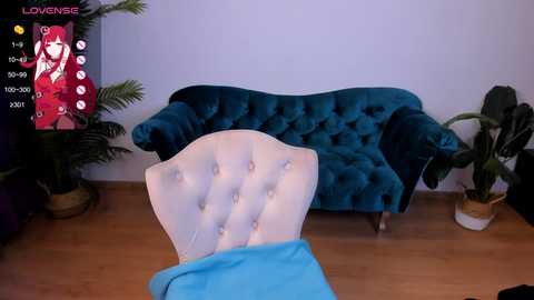 Media: A video of a plush, velvet sofa against a white wall, with a potted plant and a chair with a blue blanket. The image includes a virtual reality overlay with a woman in a red dress.