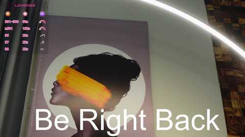 Media: Video of a modern art print on a light-colored wall. The print features a woman with curly hair, wearing a yellow blindfold, against a white background. The text \"Be Right Back\" is overlaid.