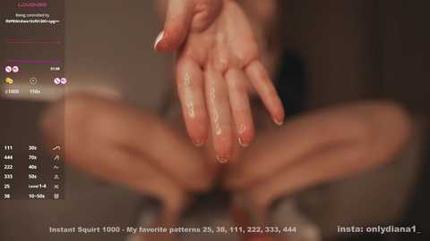 Media: A close-up video of a fair-skinned hand, fingers spread, with a textured background, blurred, and a website URL in the bottom corner.