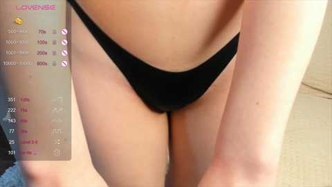 Media: A close-up video of a woman's lower torso in black panties, with a smartphone screen displaying a \"Live Meme\" interface in the background.