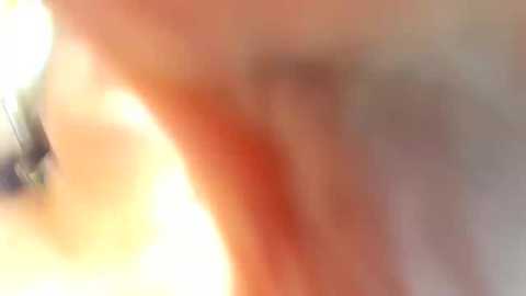 Media: A blurry, close-up video of a person's face with visible skin texture and slight redness, possibly from sun exposure or a rash. The background is indistinct and out of focus.
