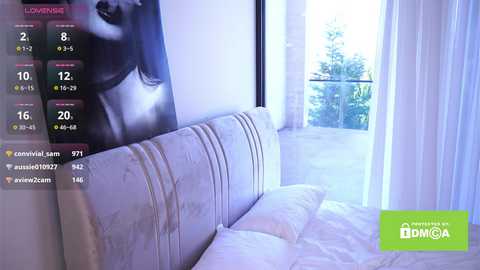 Video of a minimalist bedroom with a plush white bed, large window with sheer curtains, and a black-and-white poster of a woman's face on the wall.