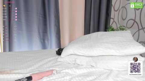Media: Video of a white bed with rumpled white sheets and pillows, dark curtains, and a potted plant on the nightstand; QR code and \"DICA\" logo in the bottom right corner.
