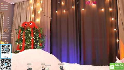 Media: A video of a festive room with a large red plush toy and a Christmas tree in the foreground, beige curtains and string lights in the background, QR code and 'Pima' logo in the bottom right.
