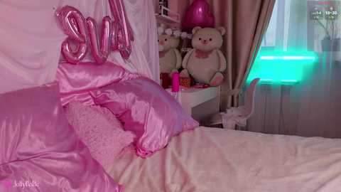 Media: Video of a cozy bedroom with pink satin sheets, stuffed animals, a glowing blue light, and a cat statue, creating a whimsical, romantic atmosphere.