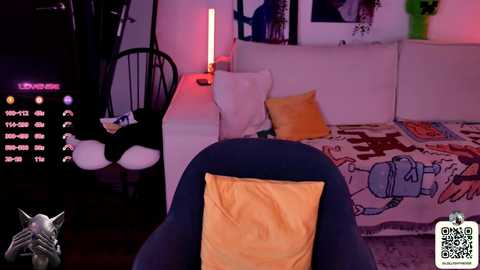 A video of a cozy, dimly-lit room with a white sofa, a bright red LED lamp, a yellow pillow, and a vibrant cartoon-themed rug.