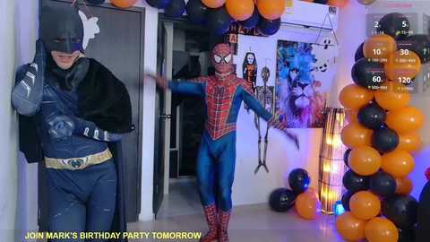 Video of a Spider-Man and Batman-themed birthday party, featuring two costumed individuals, balloons, and decorations.