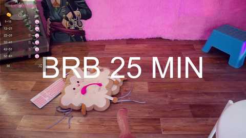 A video of a cluttered wooden floor with a pink wall, featuring a white sheep-shaped decoration, a blue stool, and a brown leather jacket on a chair.