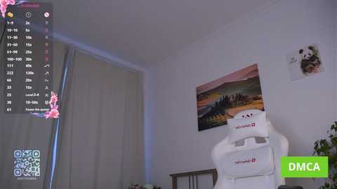 Video of a modern bedroom with a white chair, a hanging photo, and a window with white curtains. A QR code and \"DMCA\" watermark overlay the image.