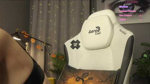 A video of a white and black Aeroflow gaming chair in a cozy, dimly lit room with fairy lights, a green plant, and a wooden desk.