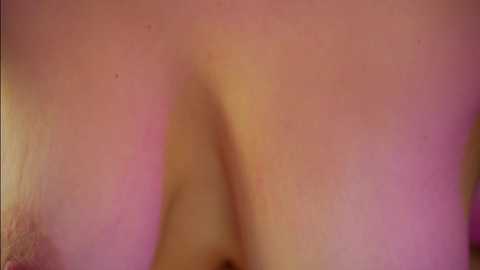 A close-up video of a person's bare buttocks, showing skin tone variations with pink and purple hues, blurred background, focusing on the texture and slight imperfections of the skin.