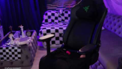A video showing a black gaming chair with green logo, set in a dimly lit room with checkered floor and purple lighting, featuring a chess set on a table.