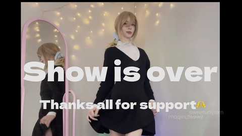 Video of a pale-skinned, blonde-haired young woman in a nun outfit, holding a black dress, with text overlay: \"Show is over. Thanks all for support.\