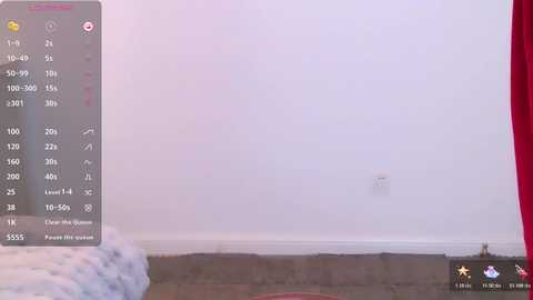 Video of a white wall with a red curtain, showing a numerical display with options like \"1.25\" and \"2.25\" on the left side.