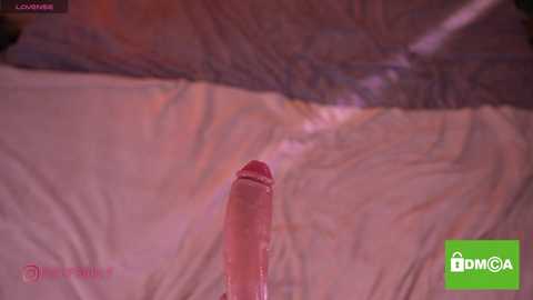 A video featuring a close-up of an erect, circumcised penis with a prominent glans, partially submerged in water. The background shows rippling, marbled surface with soft lighting, and a \"DMMO\" logo in the corner.