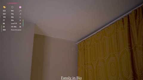 A video of a dimly lit room with beige walls and mustard-yellow curtains with a subtle geometric pattern. A digital clock with a red display and various icons is visible in the upper left corner. Text at the bottom reads \"Family in Bio.\
