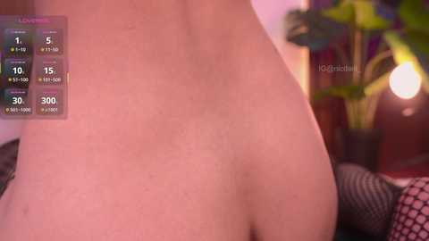 A close-up video of a light-skinned person's back and buttocks, with a digital overlay displaying workout stats and progress. Background includes a potted plant and a warm, dimly lit room.