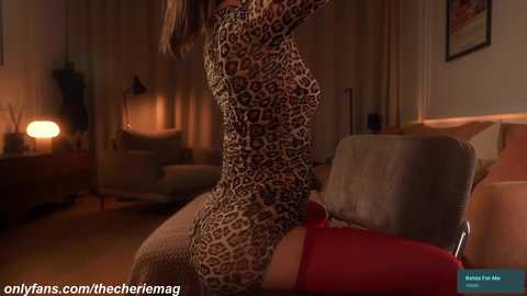 Video of a woman in a leopard-print bodysuit, sitting on a bed in a dimly lit room with beige walls and a lamp.