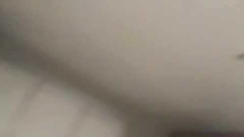 A blurred, out-of-focus video with a smoky, hazy texture. The background appears to be a dull, grayish color, suggesting a dimly lit or smoky environment. The image lacks distinct details or recognizable objects.