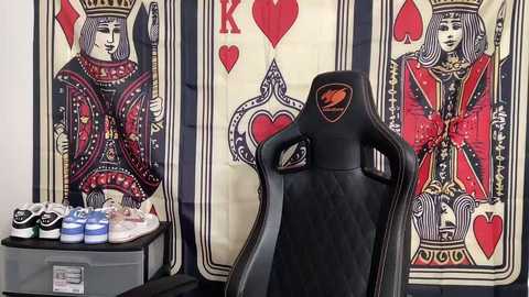 Media: A video of a black gaming chair with a skull emblem, surrounded by playing cards and a large deck of cards with red and black suits.