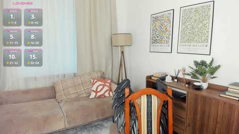 Video of a cozy living room with beige sofa, plaid cushions, wooden sideboard, potted plants, framed artwork, and vintage-style calendar overlay.