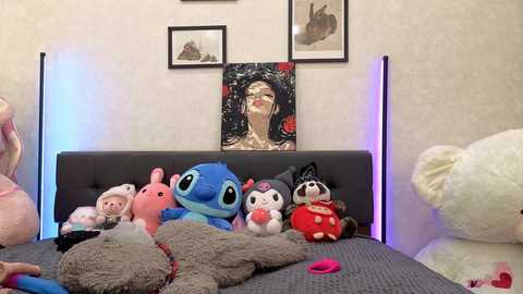 Media: Video of a plush-stuffed toy-filled bed with Disney characters, including Stitch, R2-D2, and Dumbo, against a white wall with framed artwork.