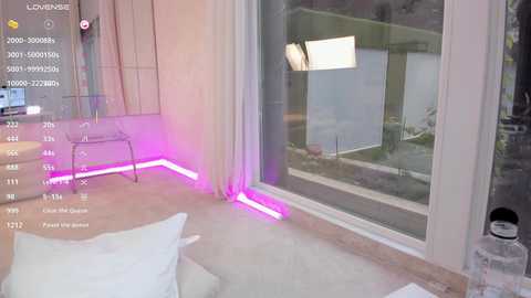 Video of a modern, minimalist bedroom with a large glass window, white walls, and neon purple floor lighting. A glass chair and a white pillow are visible.