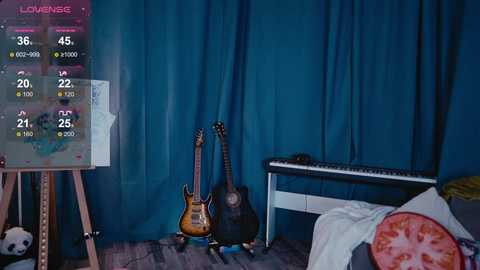 Media: Video of a cozy bedroom with a turquoise curtain backdrop, featuring an electric guitar, acoustic guitar, and a keyboard; a plush toy panda rests on the floor.