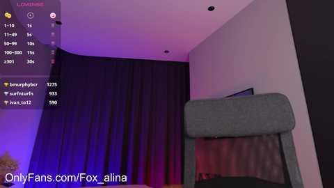 A video of a dimly lit room with a grey couch, dark curtains, and purple lighting. Text in the top-left corner reads \"LOUNGE MODE.\