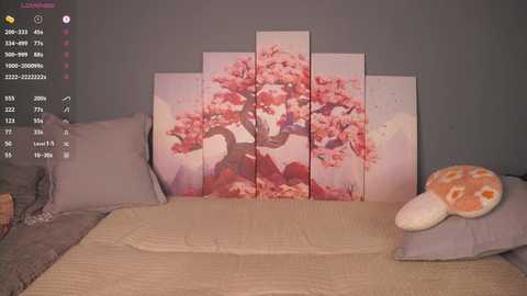 A video of a cozy, dimly lit bedroom with a beige bedspread, a gray pillow, and a large, colorful cherry blossom wall art behind it.