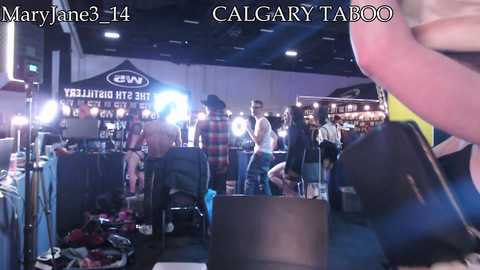 A video of a crowded bar with fluorescent lighting, featuring patrons in casual attire, including a man in a plaid shirt, and signs reading \"MaryJane3.14\" and \"CALGARY TAPROOM.\