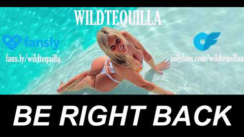 Video of a blonde woman in a white bikini, smiling and posing seductively in a pool. Text overlays: \"WILDTOULLA\" and \"BE RIGHT BACK\" in bold white letters.