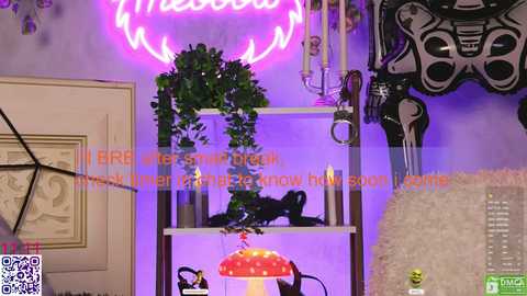 Video of a modern, colorful room with a neon \"Witch\" sign, a plant stand, a red mushroom lamp, and black decorative pieces against purple walls.