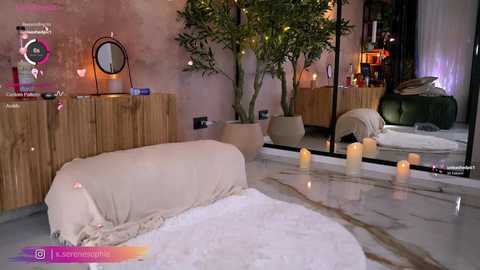 Video of a serene, dimly lit room with a beige cushioned mat, white candles, a wooden cabinet, a plant, and a large mirror.