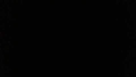 A video with a dark, almost pitch-black background, devoid of any visible objects or elements, creating an empty, void-like effect.