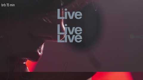 Video of a dimly lit, shadowy room with a \"Live Live\" watermark in the center. The background is dark, with a faint red glow and indistinct shapes, suggesting an intimate, possibly private setting.