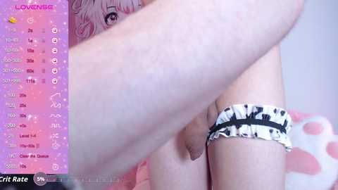 Media: Video of a fair-skinned person in lingerie with a pink bow, standing in a bedroom with a pink background.