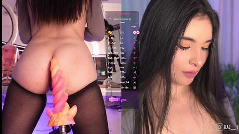 Video of a woman with long black hair and fair skin wearing black thigh-high stockings, bent over with a pink and orange dildo inserted, displayed on a screen.