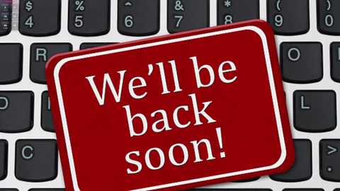 Video of a red warning sticker on a black keyboard, with white text reading \"We'll be back soon!\" against a white background.